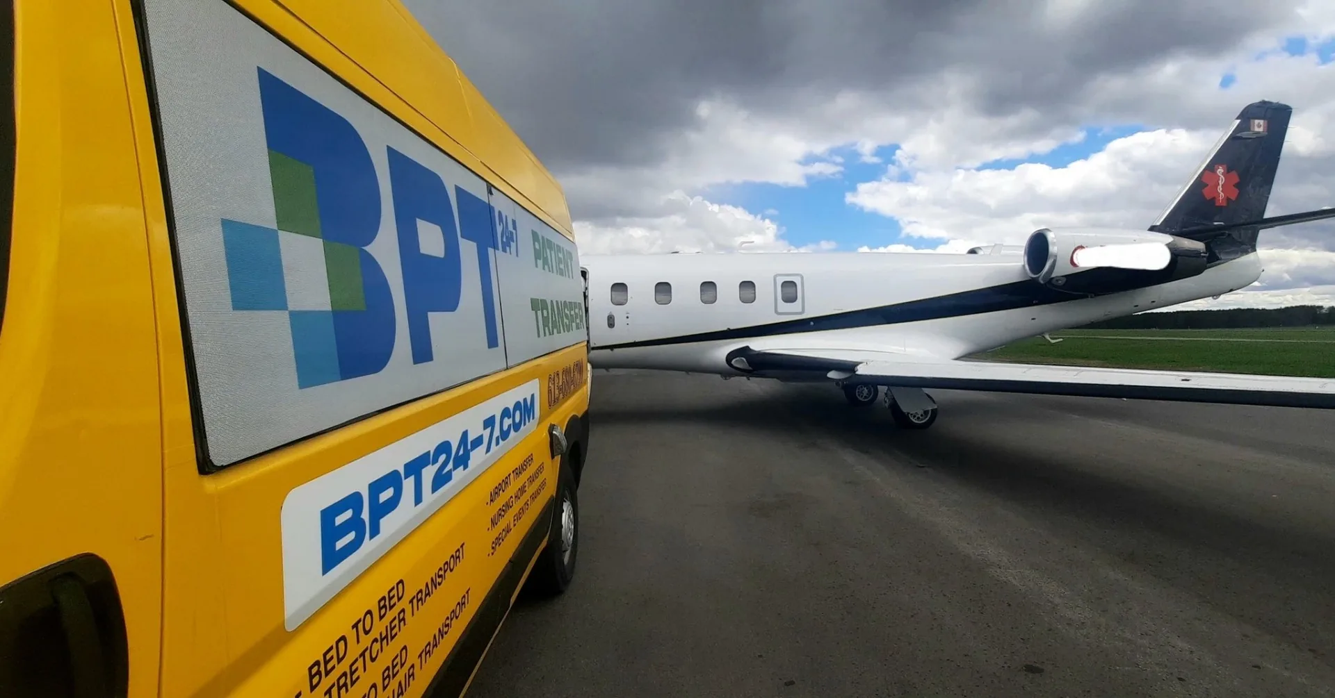 BPT24-7 stretcher transport van on the tarmac next to a medical air-ambulance jet at Ottawa International Airport (YOW)